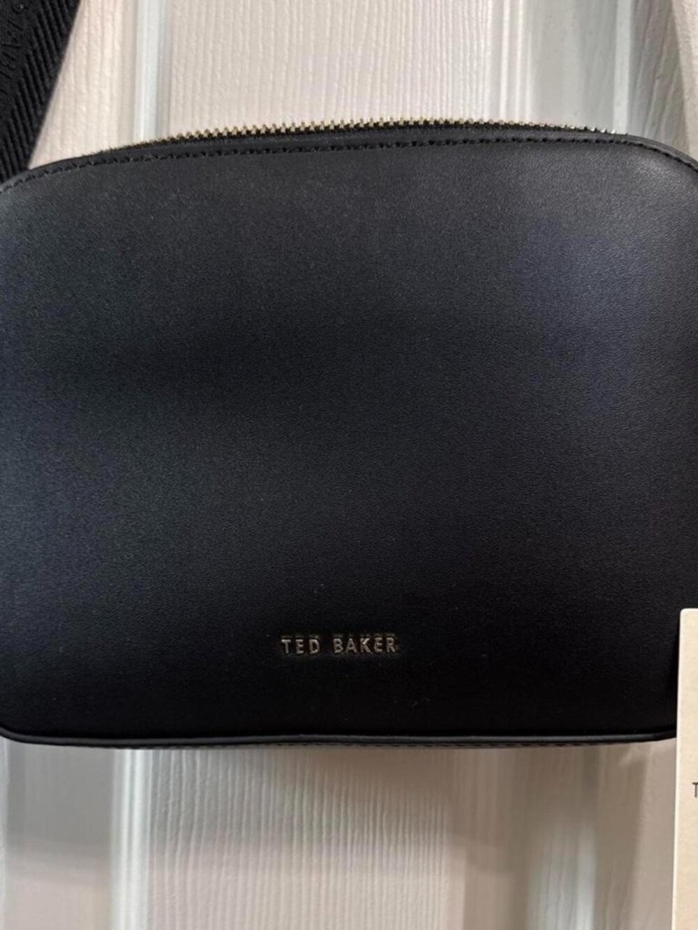 Ted Baker black crossbody camera bag with gold hardware and adjustable strap